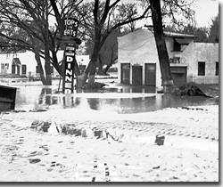 In March 1938 the Santa Ana River overtopped its banks and flooded a portion of northwest Riverside. Note the high water mark on the trees.