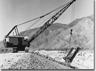 Placing rock revetment on the San Jacinto River Levee during its construction by the Corps of Engineers in 1961.